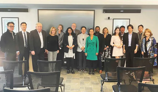 Group photograph of Private Biotech Summit participants standing together in a meeting room
